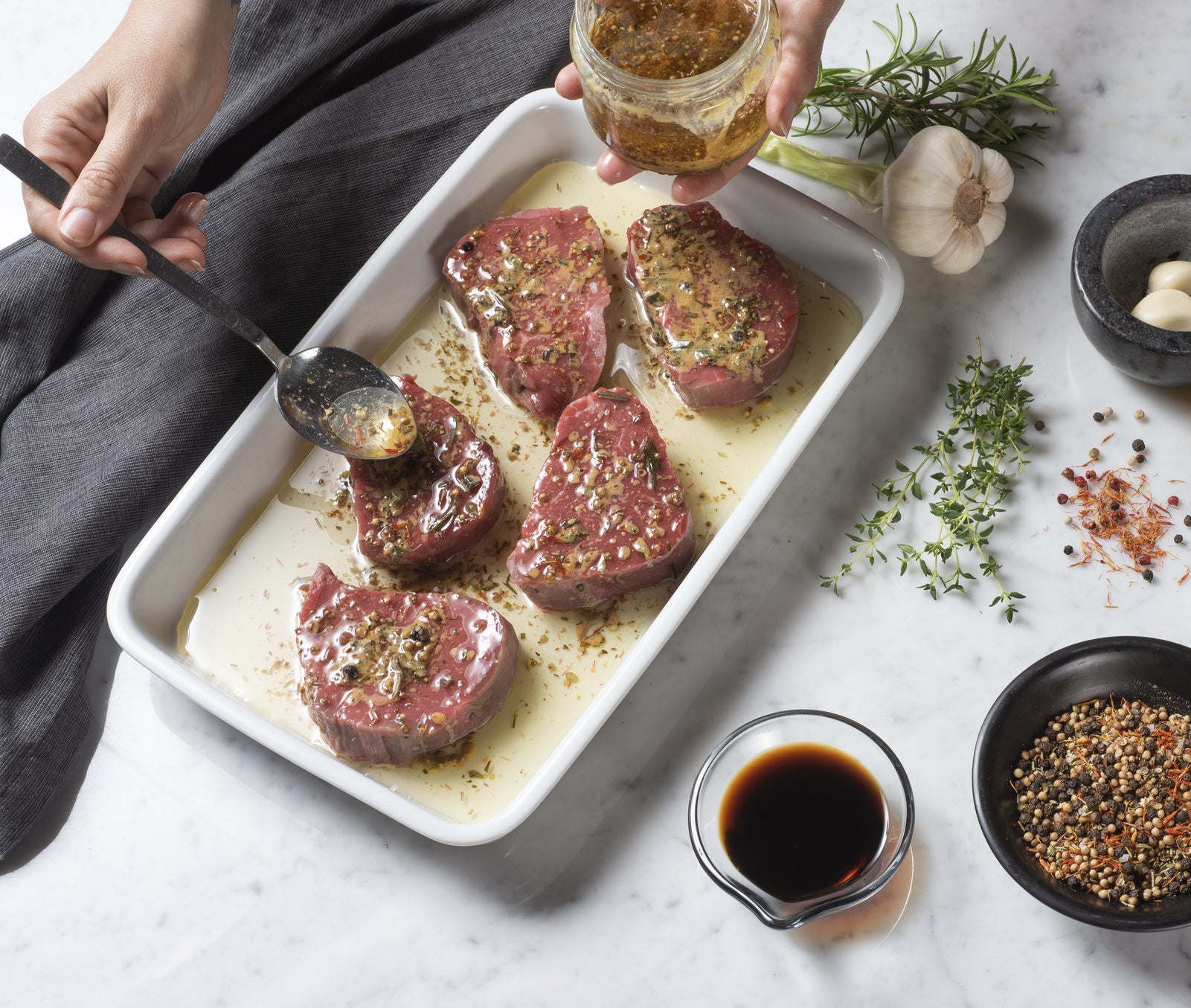 A woman marinating meat