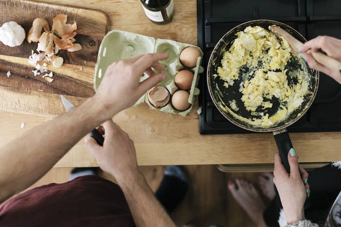 A couple making scrambled eggs