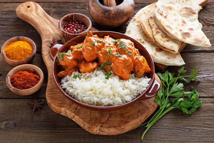 a pan of butter chicken and rice