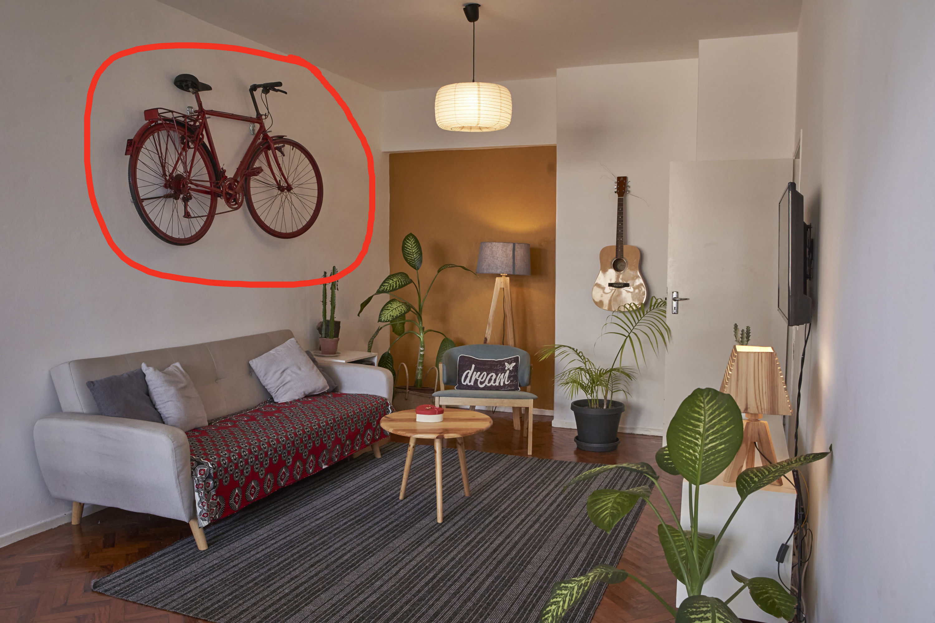 a living room with a circle around a hanging bike