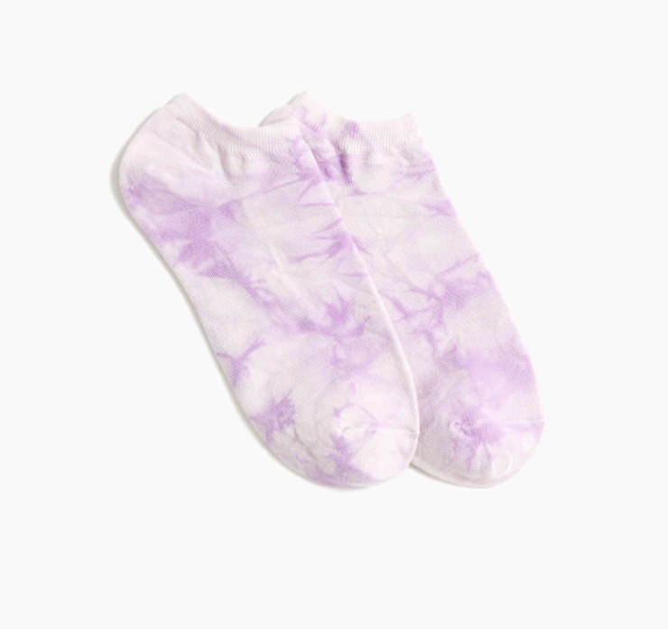 An image of a pair of purple tie-dye ankle socks that are fully machine washable