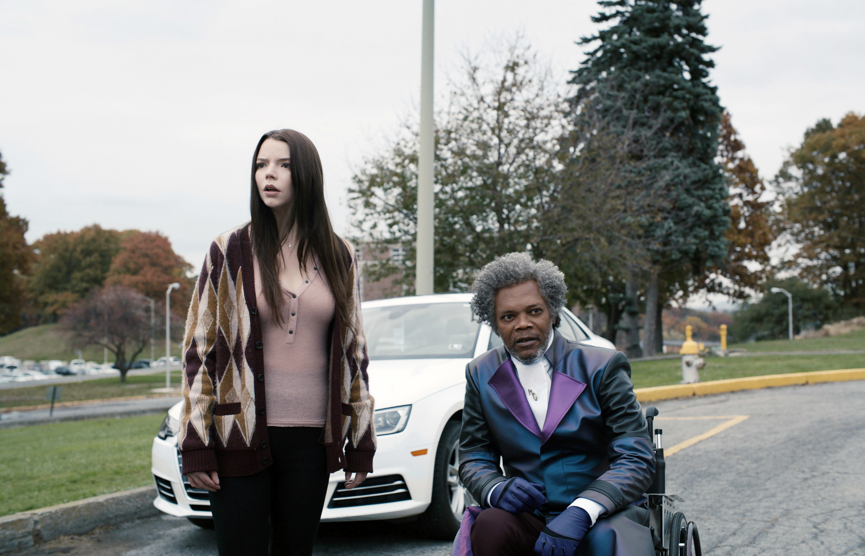 Anya Taylor-Joy stands beside Samuel L. Jackson in a wheelchair
