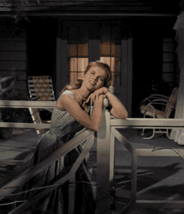 Woman on porch daydreams