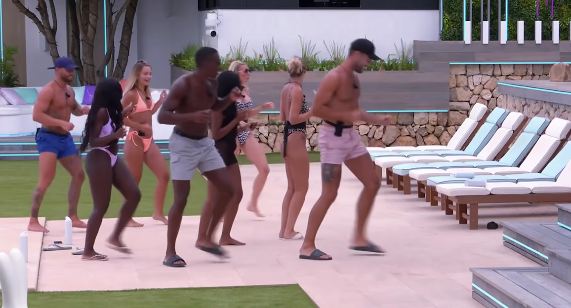the group in their swim attire dancing outside
