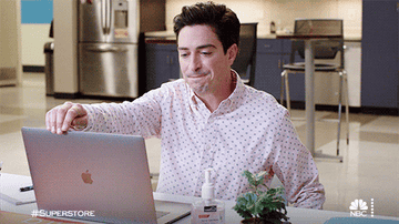 Man closes laptop at work