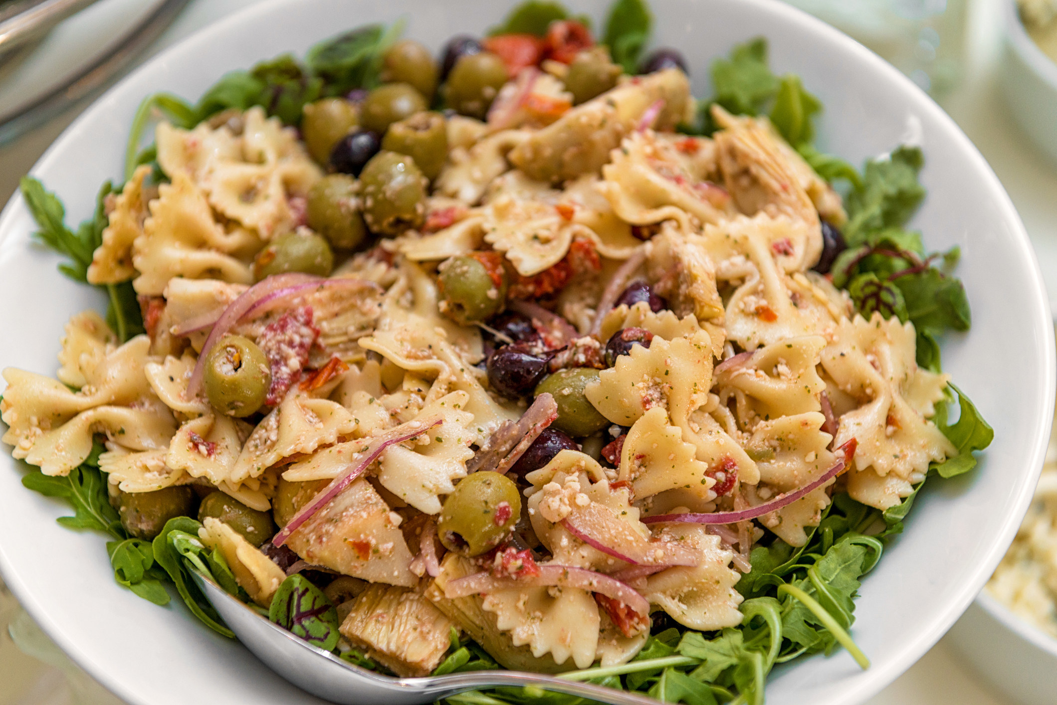 a bowl of bow tie pasta salad