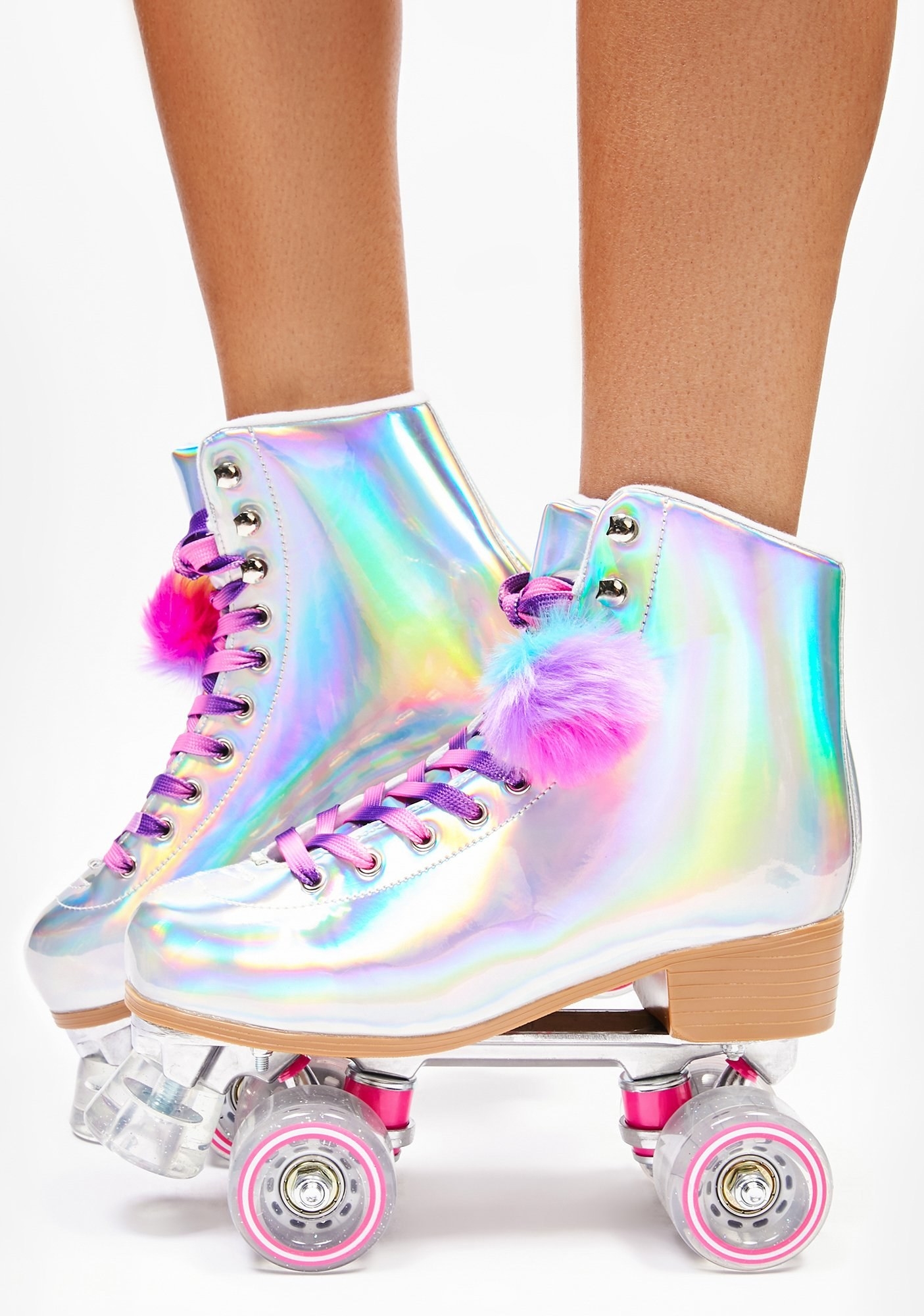 model wearing rainbow holographic skates with pom pom details