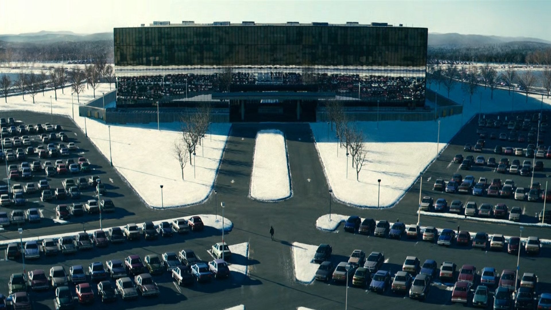 The parking lot next to a large office building is seen