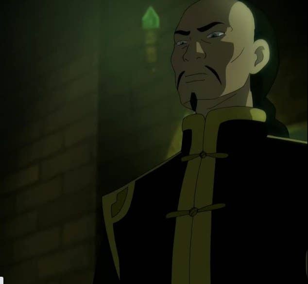Long Feng wears a high-neck dark robe