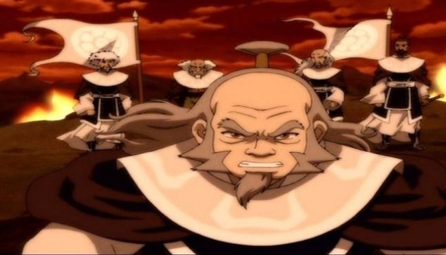 Iroh wears a wide collar robe while a fire rages behind him