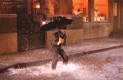 Gene Kelly in Singing in the Rain splashing in a puddle