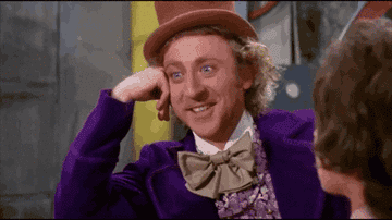 A gif of Gene Wilder&#x27;s Willy Wonka looking at all of the chocolate factory tour attendees.