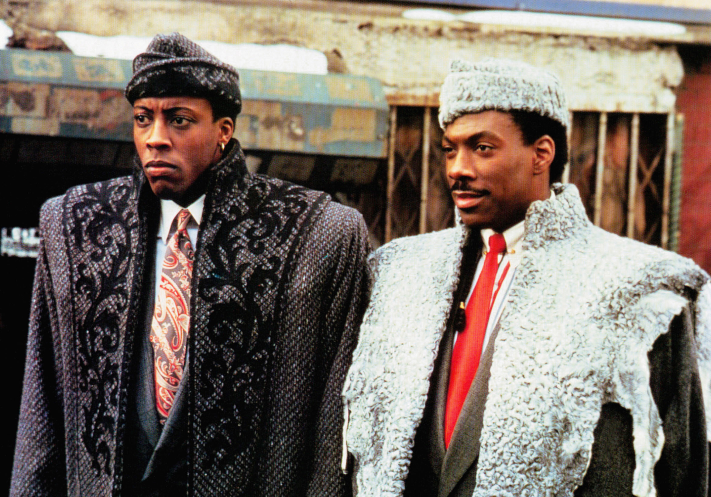 Arsenio Hall and Eddie Murphy in suits, coats, and hats