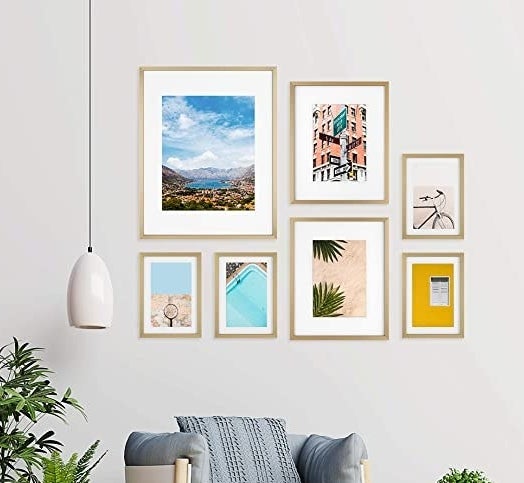 The frames on a wall above a chair