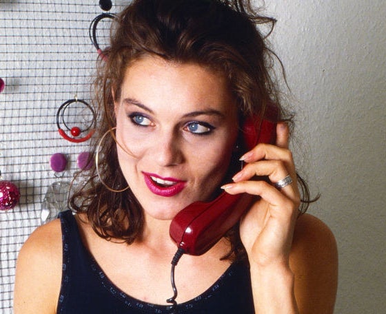 A woman using a landline phone.