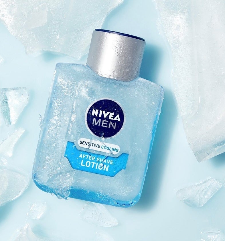 A bottle of after shave balm with cracked ice around it