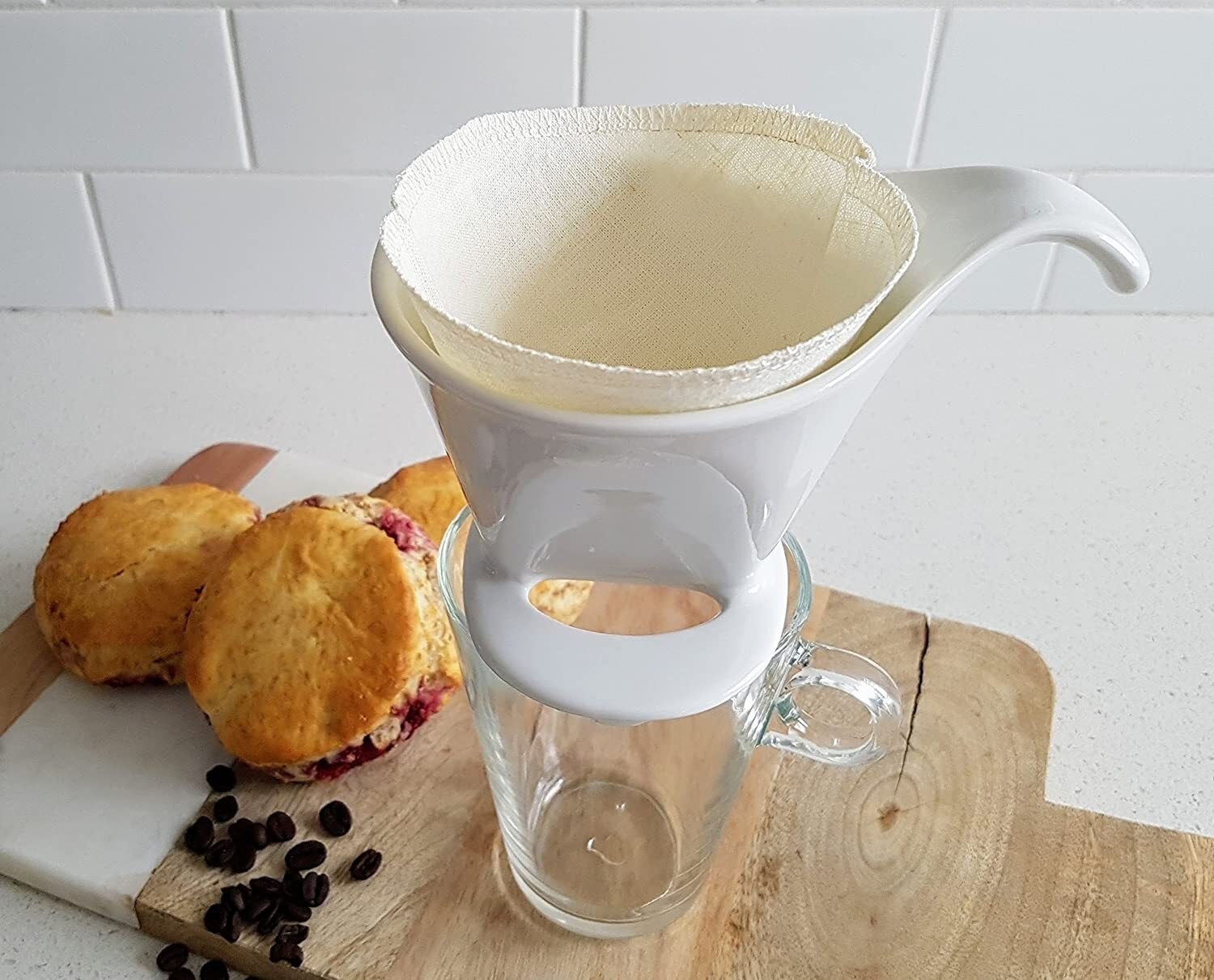 A coffee filter in an over pour coffee maker that&#x27;s placed on top of a glass mug