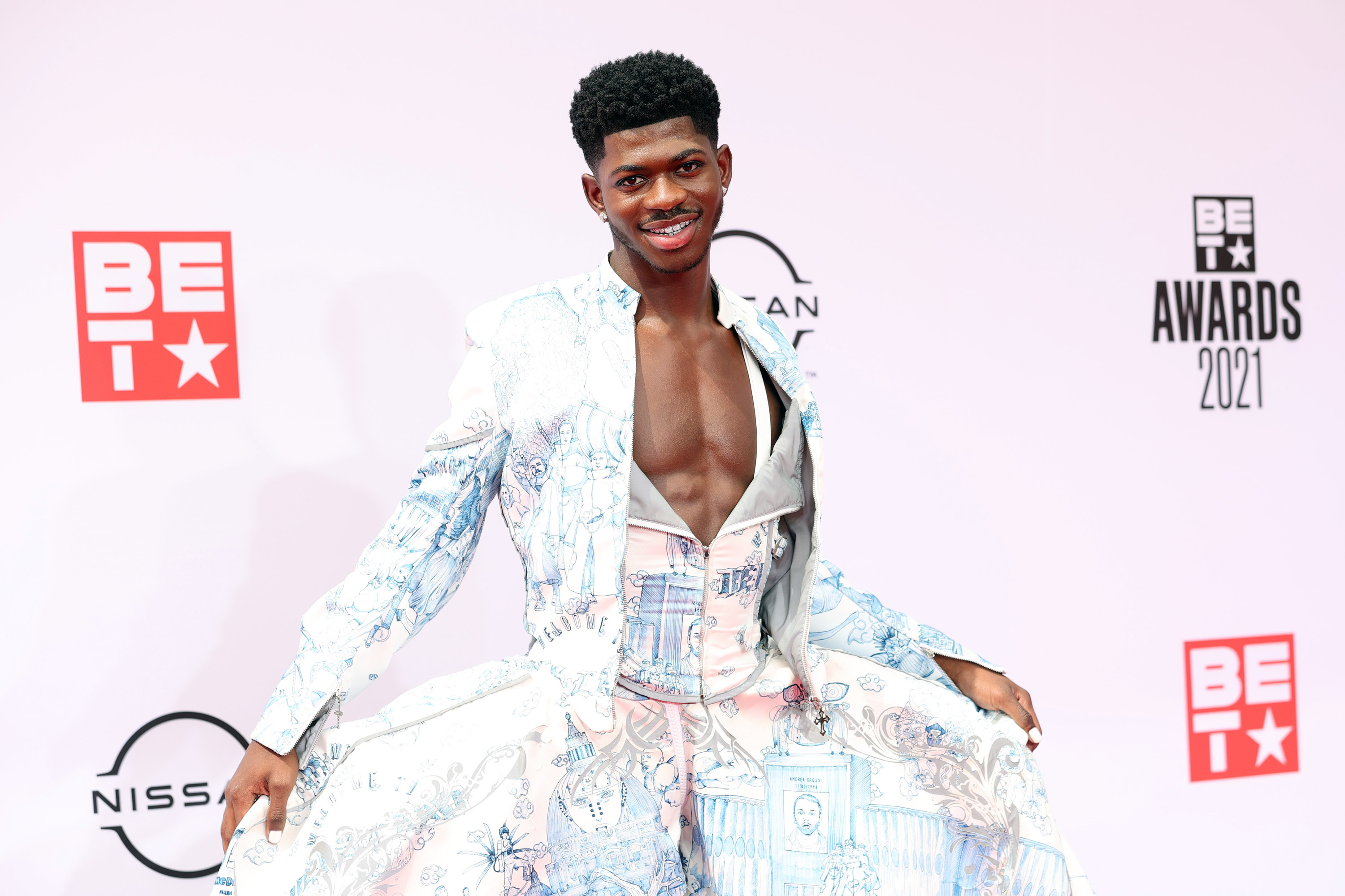 Lil Nas X in the outfit, holding out his skirts