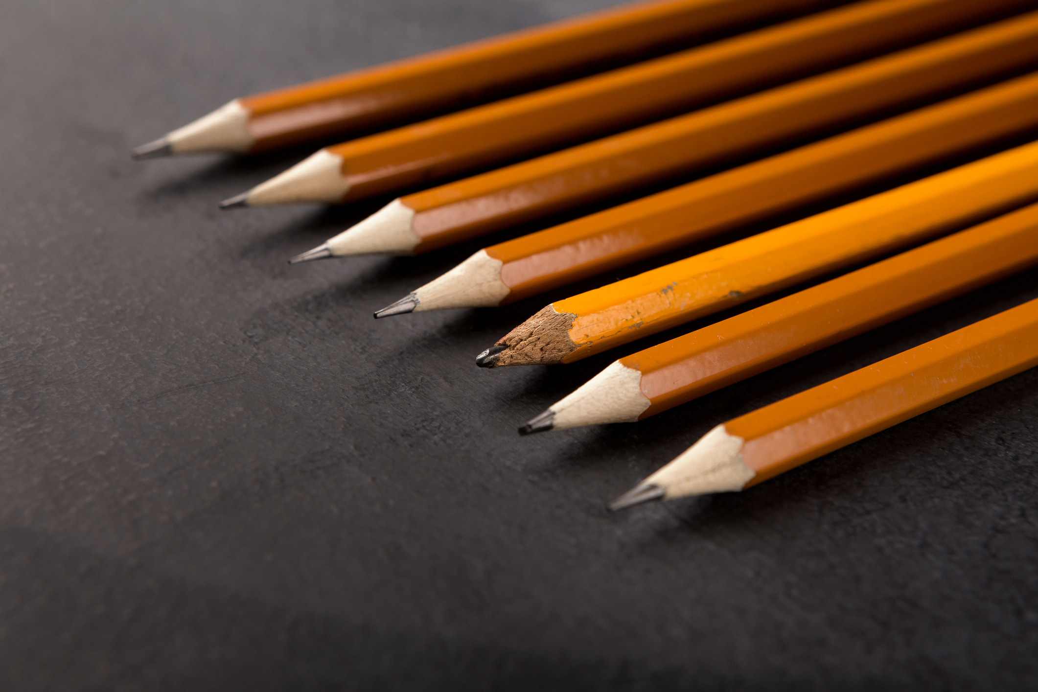 A row of sharpened pencils and one old, dull one