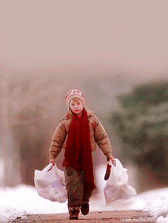 Macaulay Culkin as Kevin McAllister in &quot;Home Alone&quot; walks down the street with grocery bags that suddenly rip open