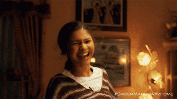 A GIF of Zendaya from Spider-Man smiling and pumping her fists in the air