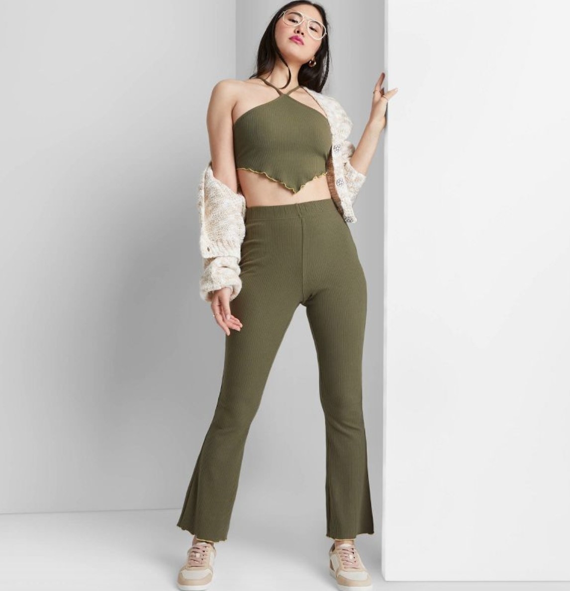 a model wearing the pants and matching top in green