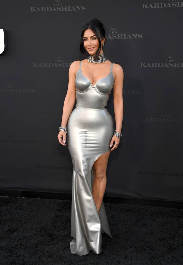 Kim in a skin-tight column dress with a fishtail hem