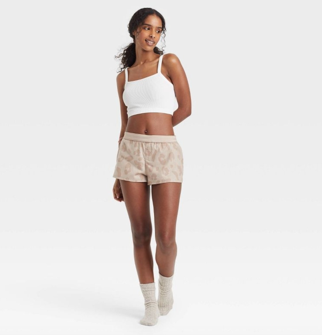 a model wearing the sleep shorts in cheetah print