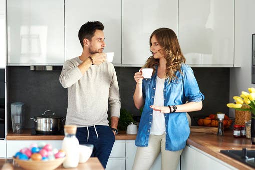 Couple drinking coffee in kitchen