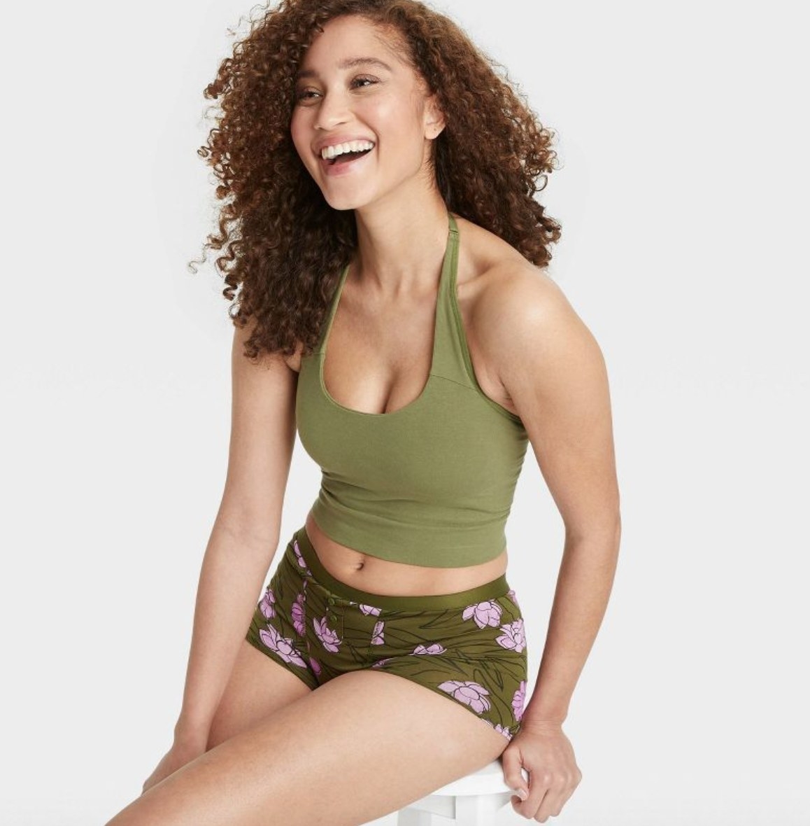 a model wearing the top in green