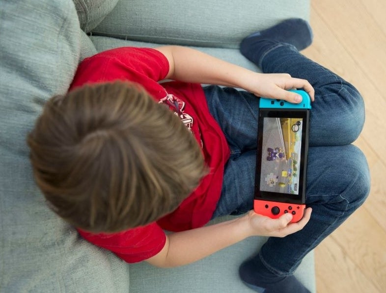 a kid playing a hand held game