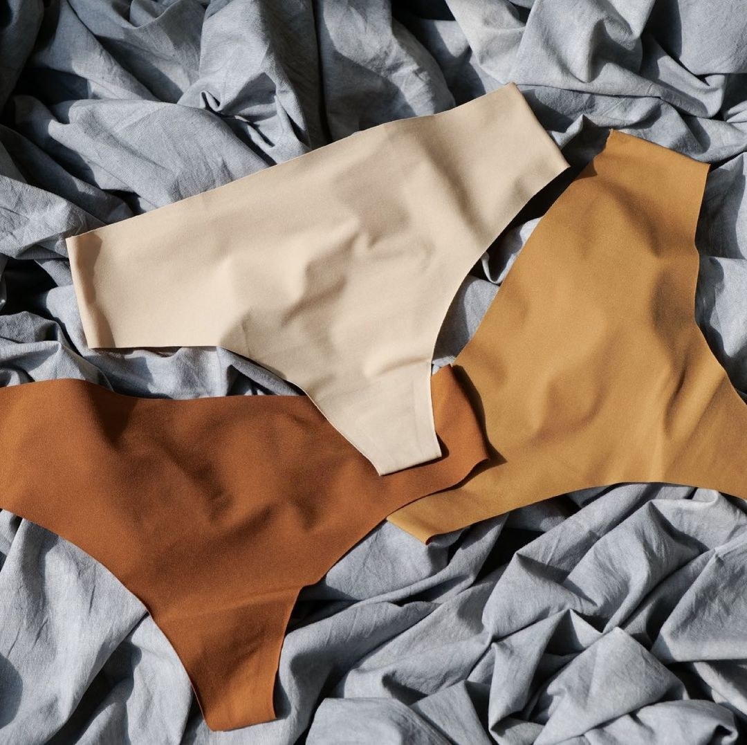 Three thongs on a crumpled sheet