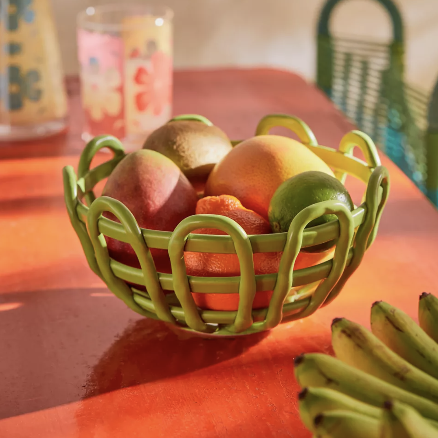 The bowl on a table filled with a variety of fruit