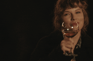 GIF of Taylor Swift holding a wine glass