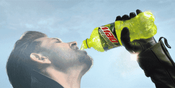 a man chugging mountain dew