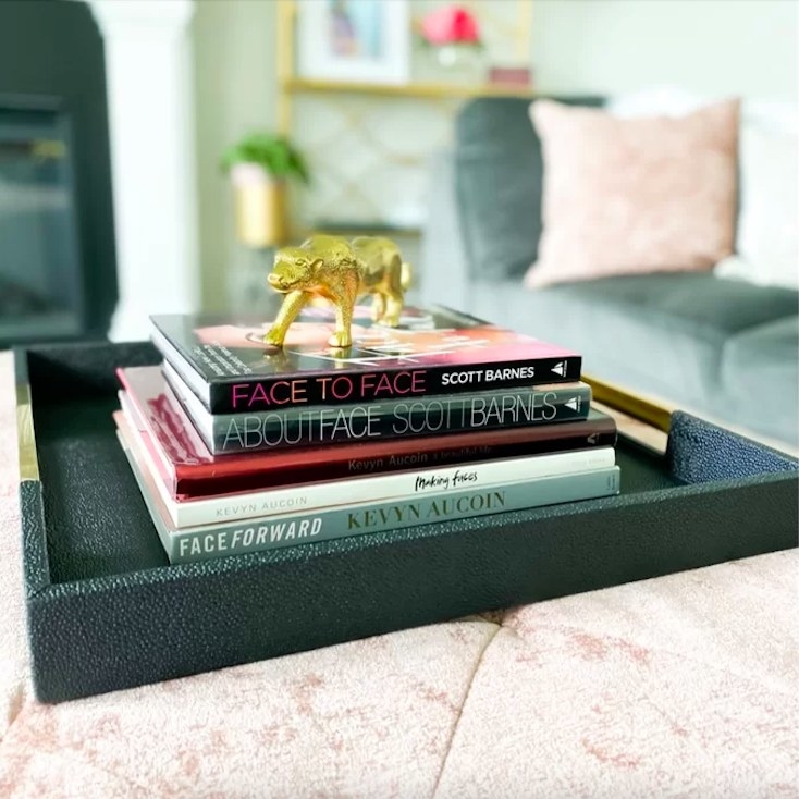 Reviewer image of tray with a stack of books and a gold accessory