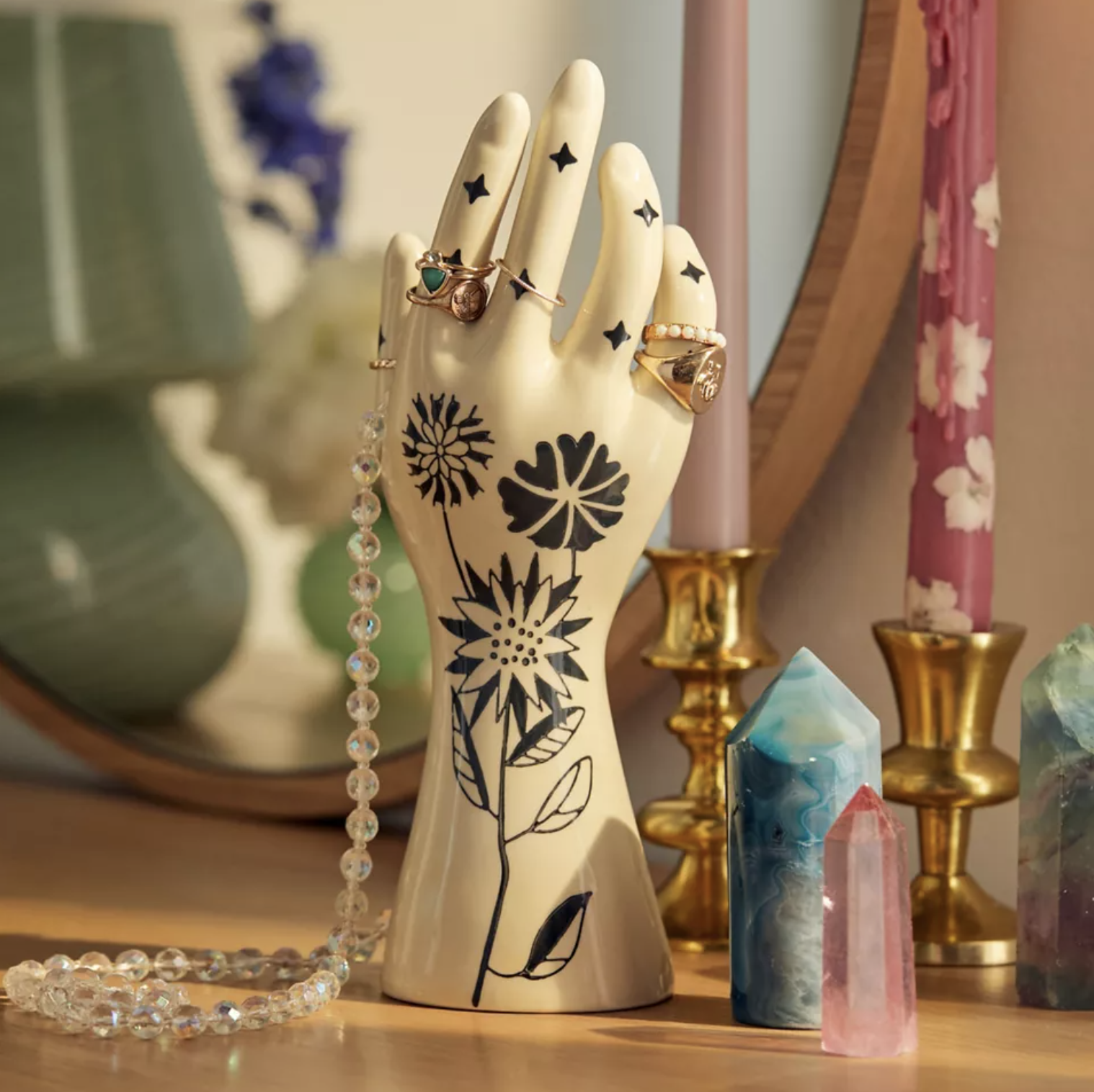 The hand jewellery stand with jewellery displayed on it