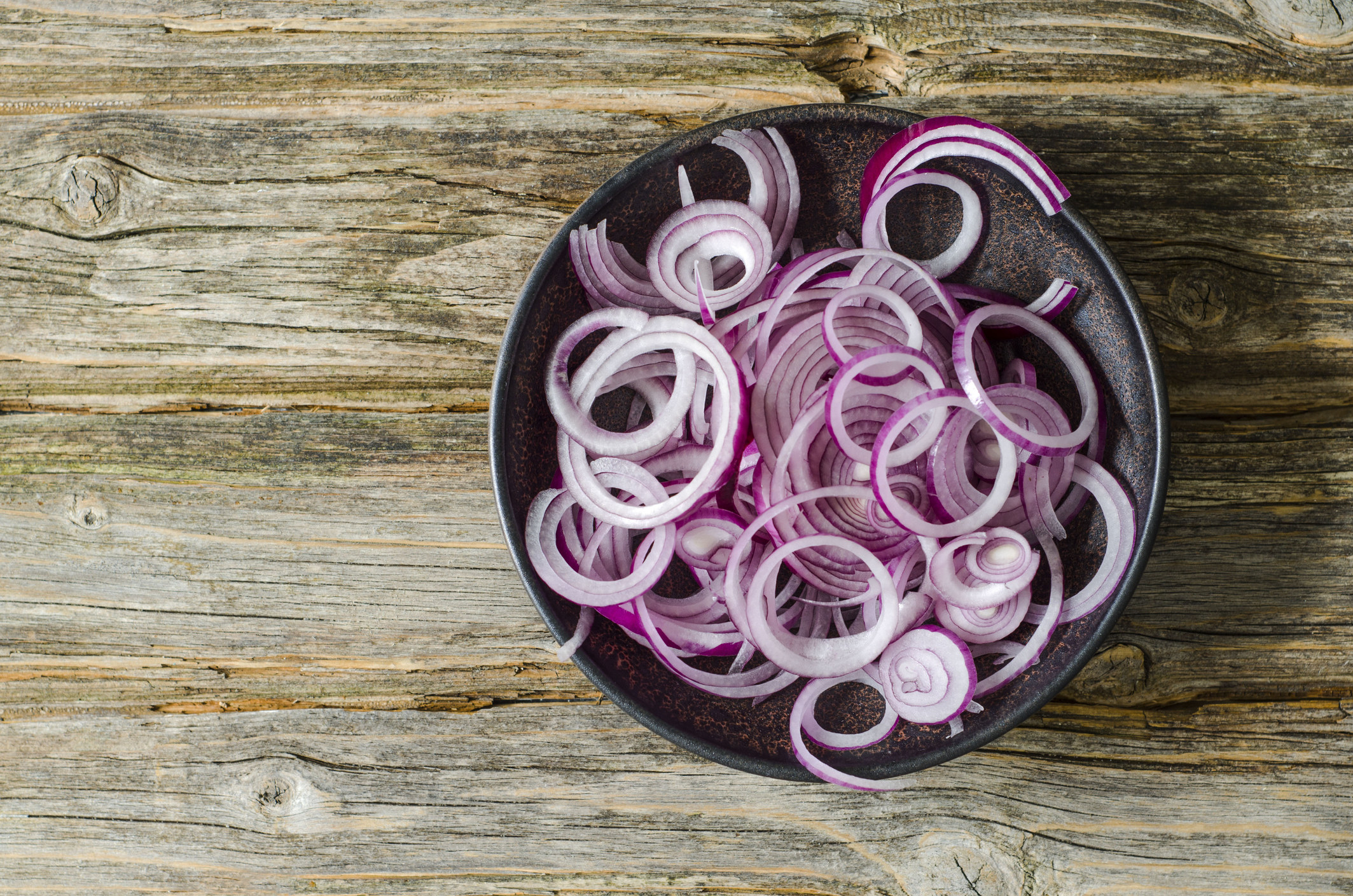 A bowl of sliced red onion
