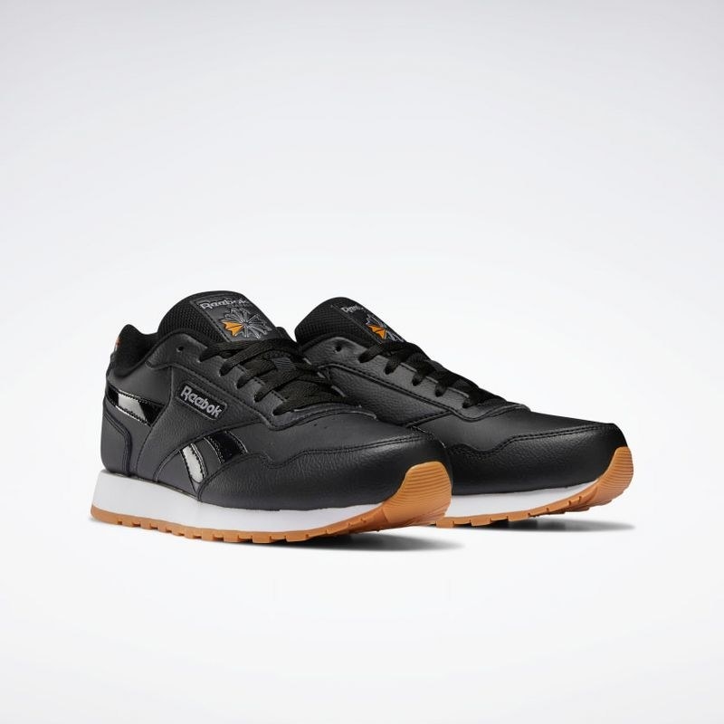 The black Reebok classic running shoes with brown soles