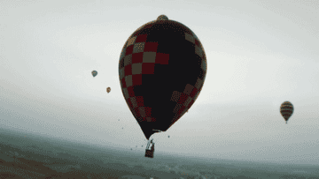 An aerial view of hot air balloons in the sky