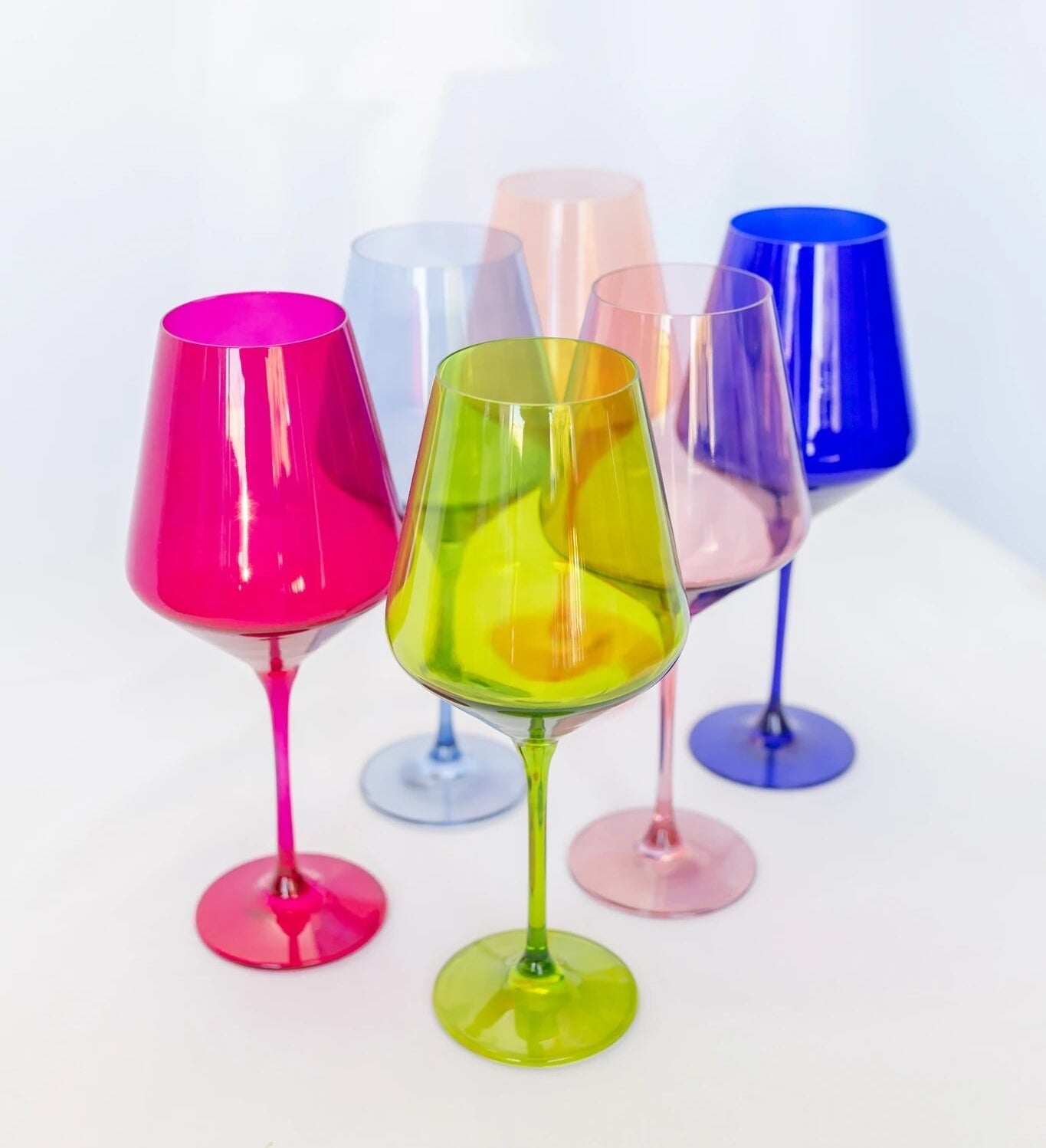 six different colors of stemmed wine glasses