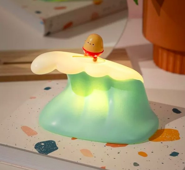 tiny potato in swimsuit riding light up wave