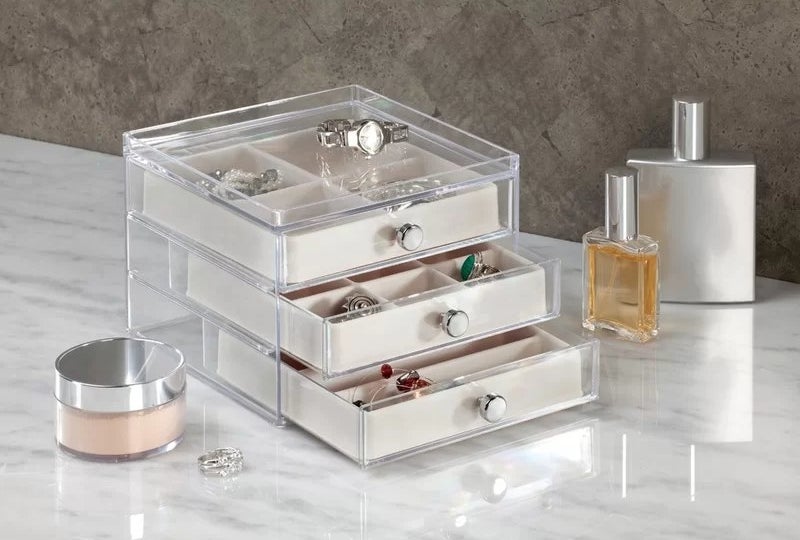 the box on a counter with jewelry in it