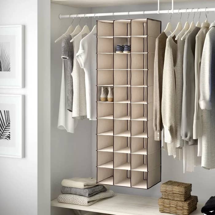 A hanging shoe organizer in tan for 30 pairs of shoes