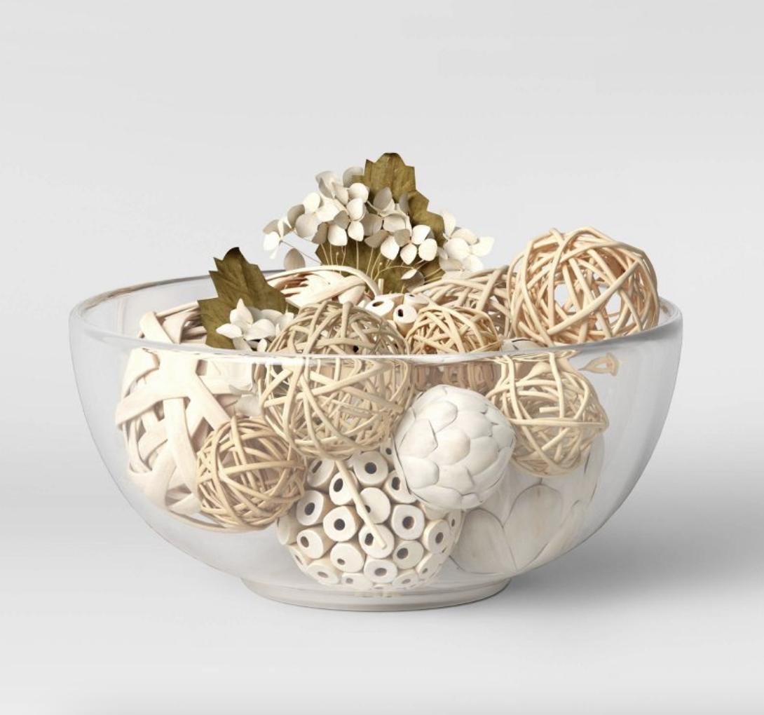 A glass bowl filled with wicker balls.