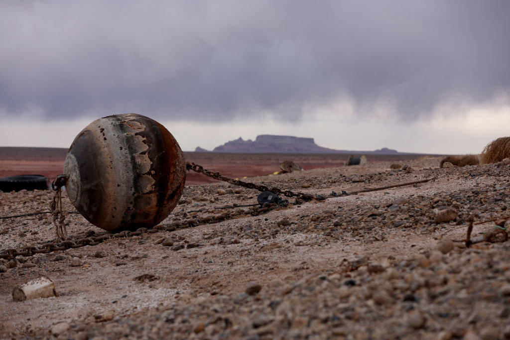 A buoy that would normally be floating on top of water now looks chained to cracked earth, and it&#x27;s become covered in rust