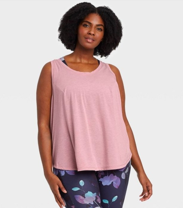 Model wearing pink tank top and floral print leggings