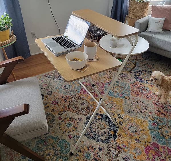 a reviewer photo of the desk with light wood and white legs