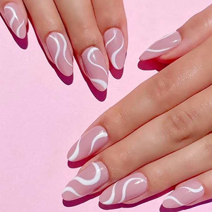 hands with pink and white swirly nails