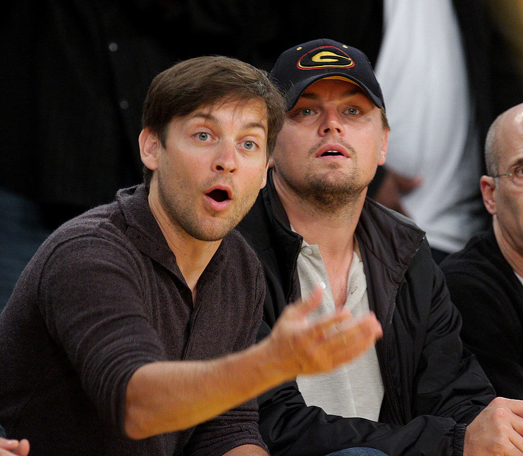 Tobey and Leo looking at a sports team play